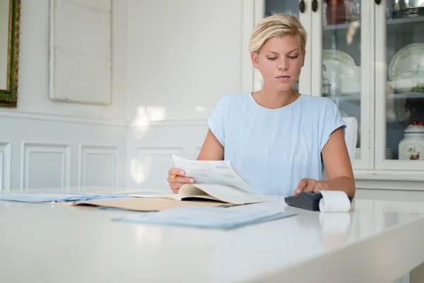depositphotos_13887246-stock-photo-young-woman-checking-bills-and